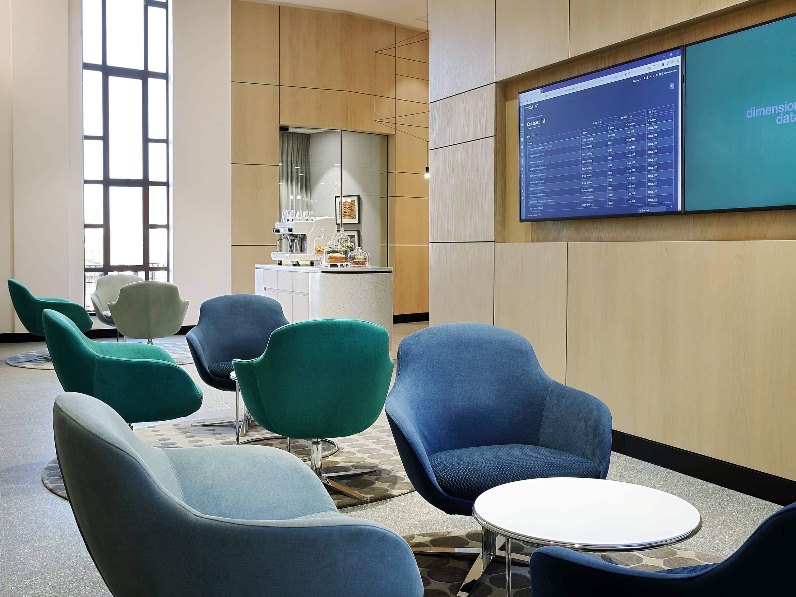 Modern airport members' lounge with comfortable armchairs and food station. Elsa Young Photography. Modern airport members' lounge with comfortable armchairs and food station. Elsa Young Photography.