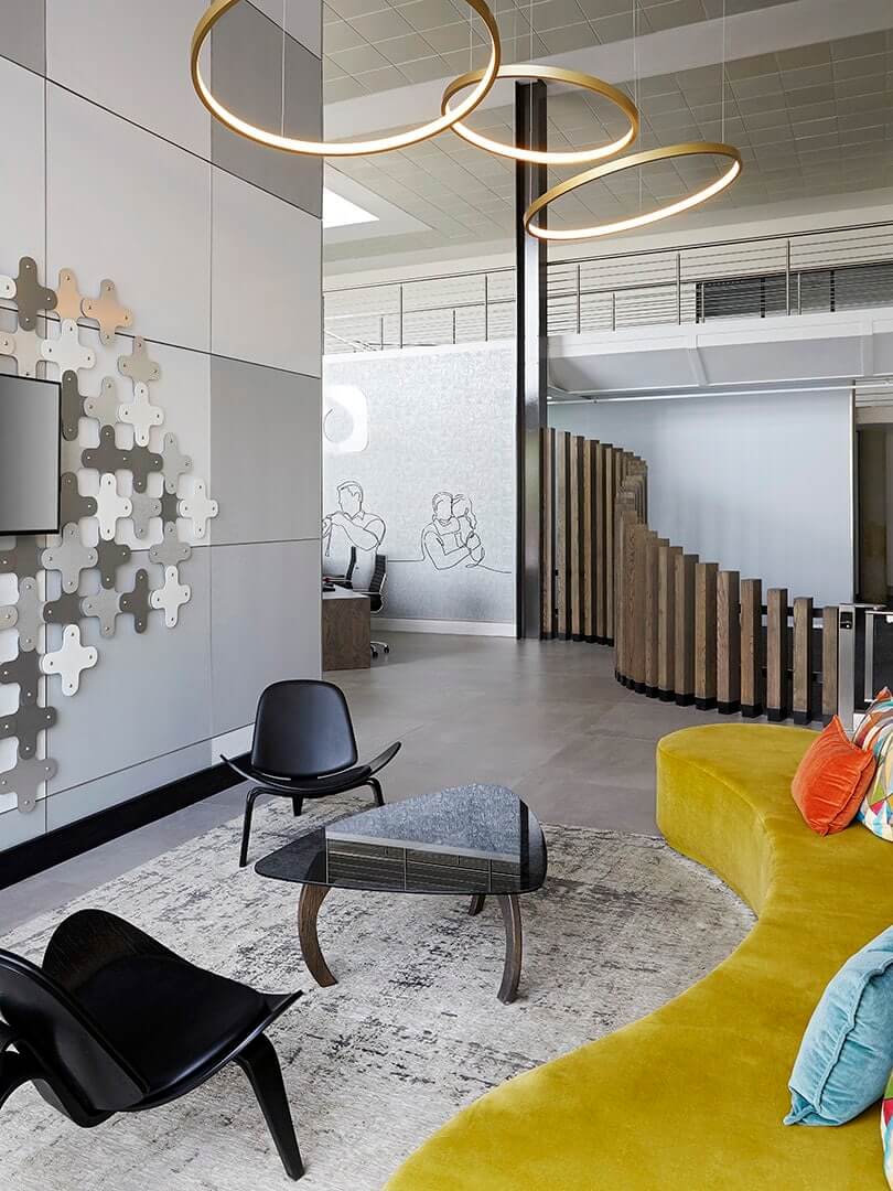 Playful company reception area with a brightly coloured couch and modern chairs. Elsa Young Photography. Playful company reception area with a brightly coloured couch and modern chairs. Elsa Young Photography.