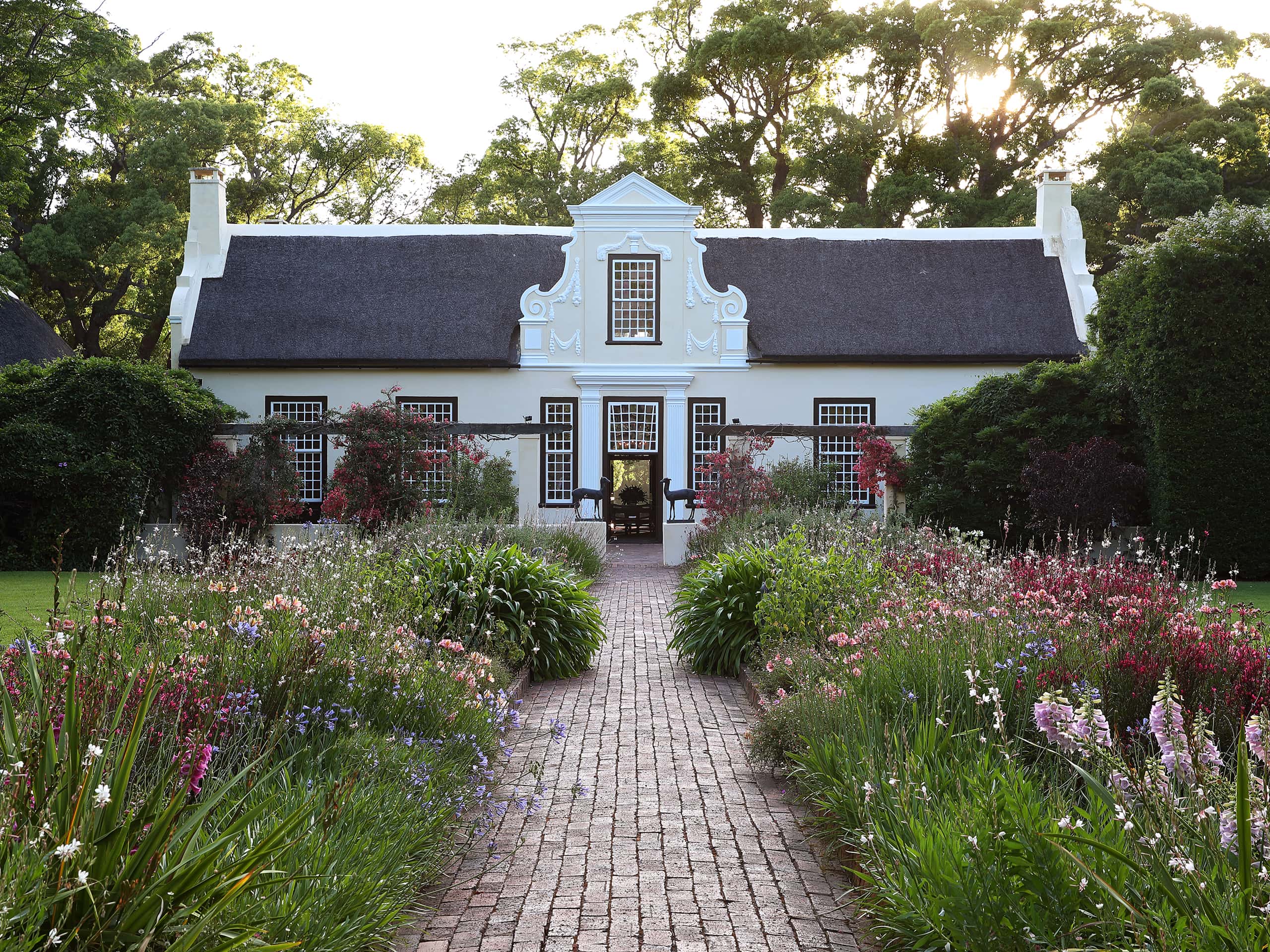 Exquisite Cape Dutch building in the bucolic gardens of Vergelegen, Western Cape. Photo by Elsa Young. Exquisite Cape Dutch building in the bucolic gardens of Vergelegen, Western Cape. Photo by Elsa Young.