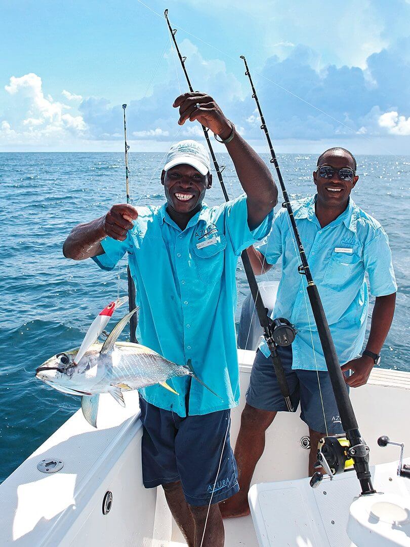Two men smiling on a boat after having just caught a fish. Photo by Elsa Young. Two men smiling on a boat after having just caught a fish. Photo by Elsa Young.