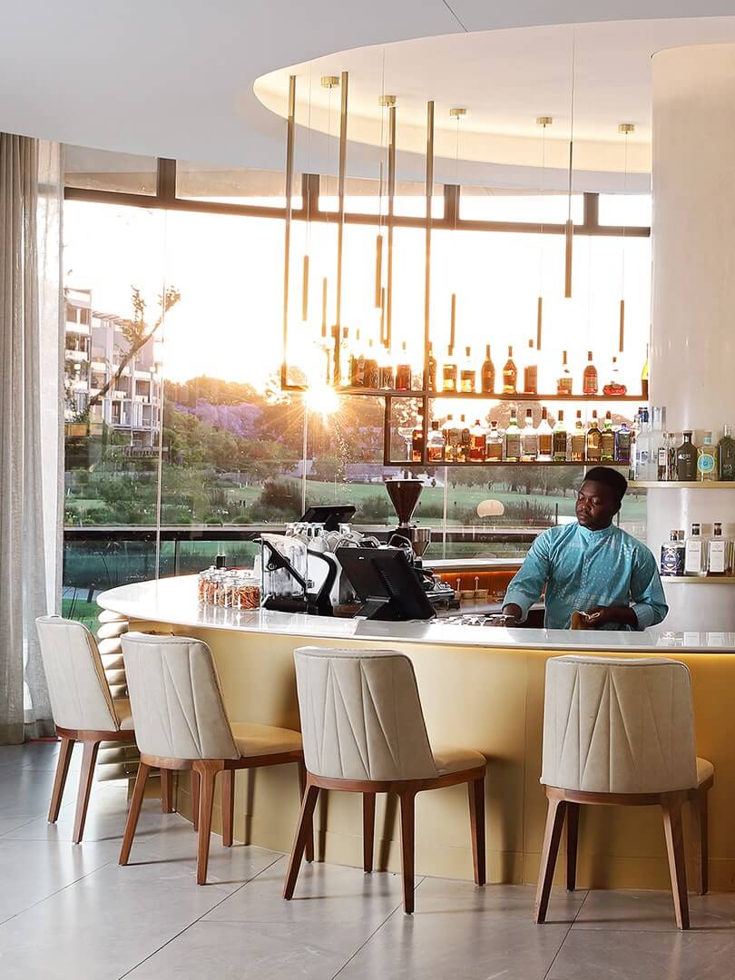 Barman behind his counter cleaning glasses at the elegant Houghton Hotel and Spa. Photograph by Elsa Young. Barman behind his counter cleaning glasses at the elegant Houghton Hotel and Spa. Photograph by Elsa Young.