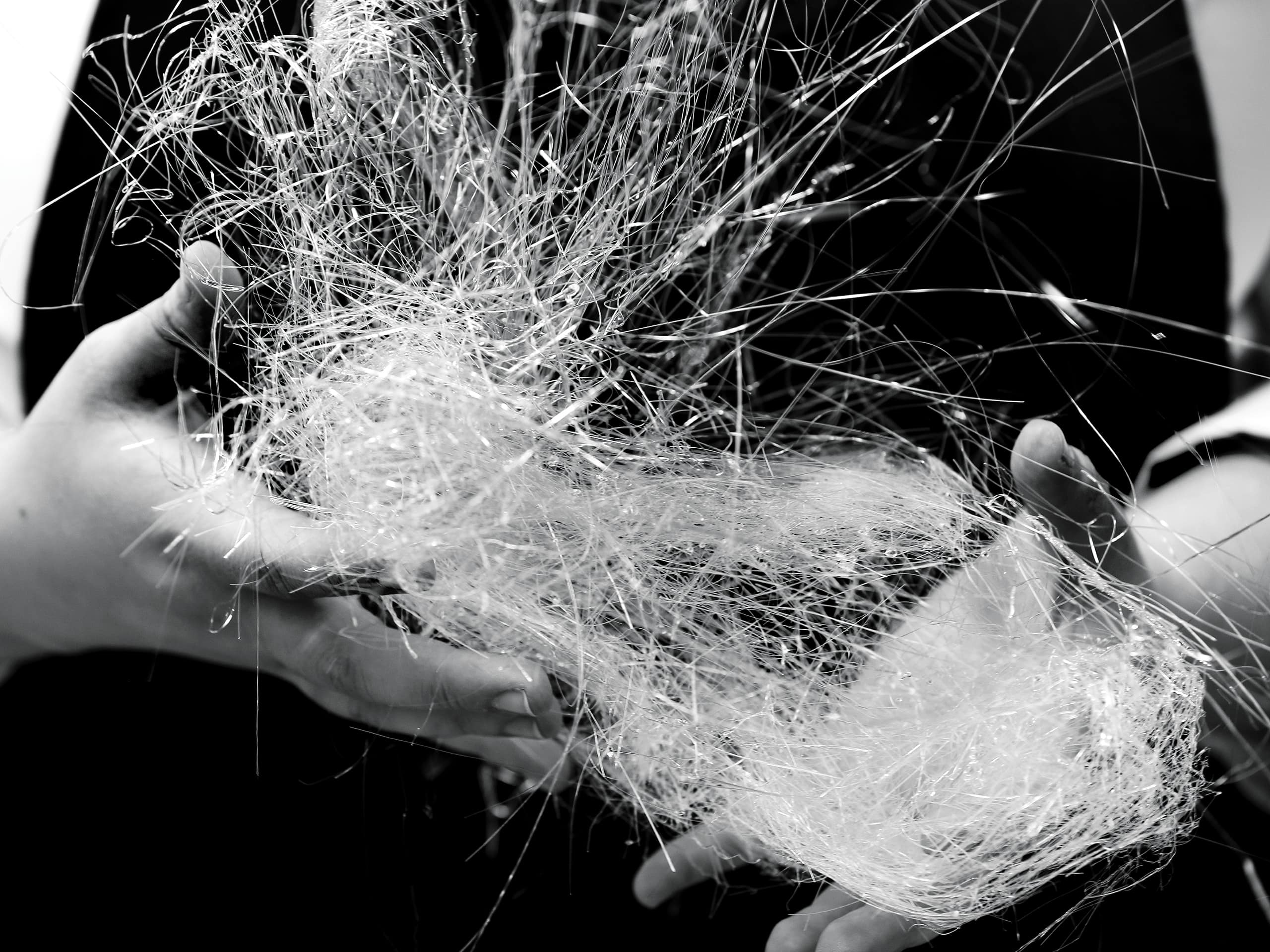 Chef's hands holding spun sugar. Chef's hands holding spun sugar.