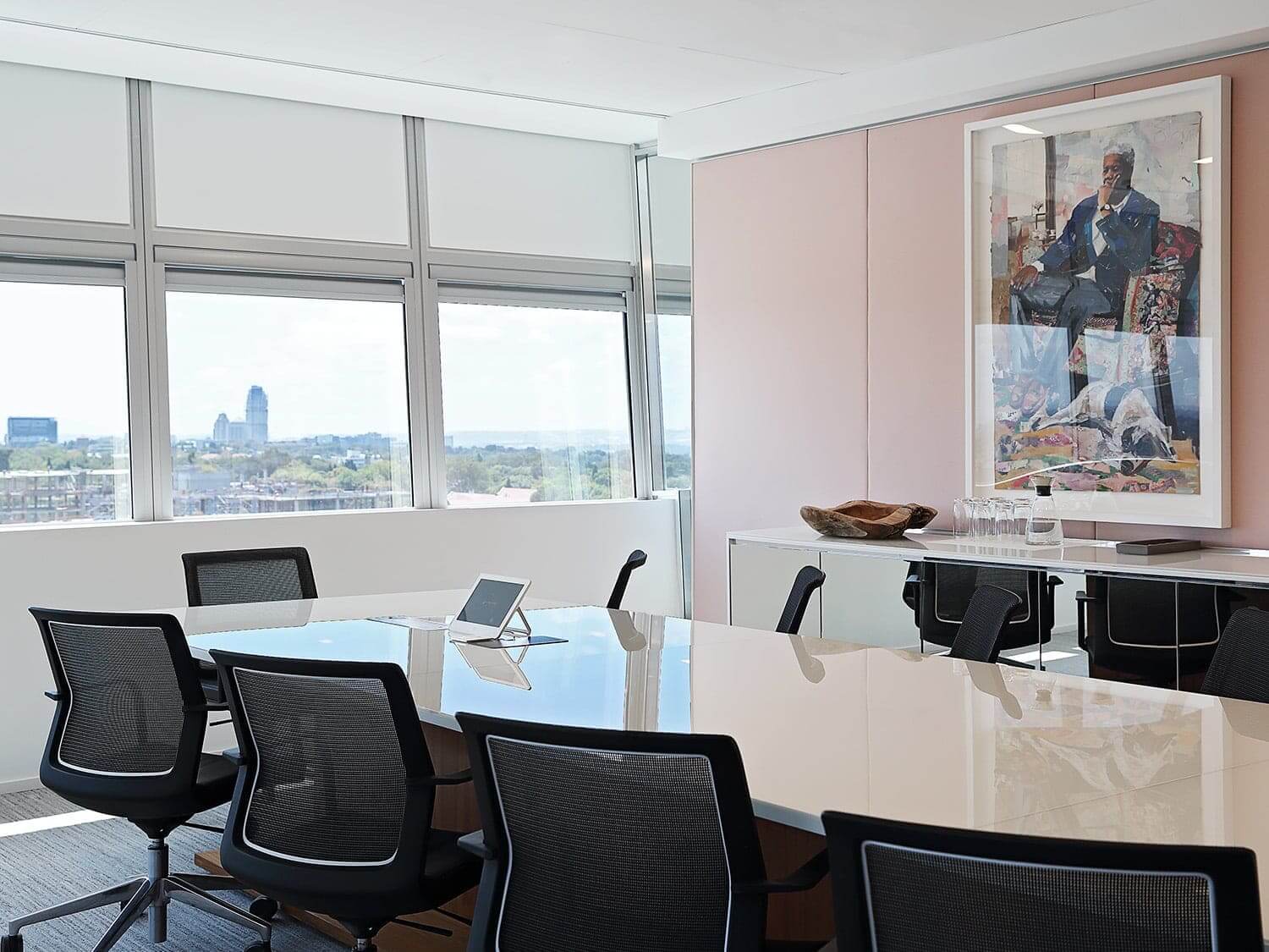 Modern baordroom with city view and original art on the walls. Photograph by Elsa Young.