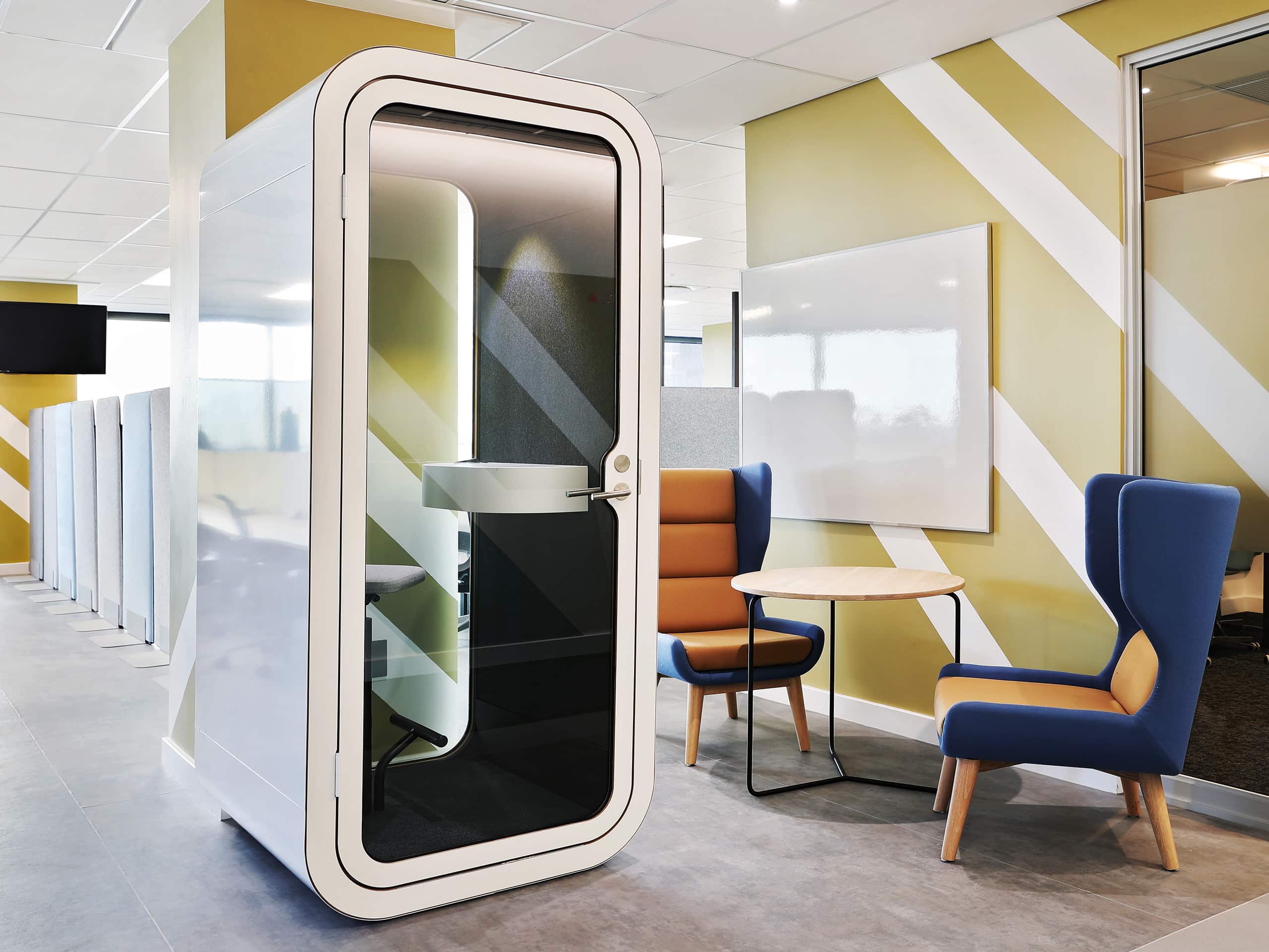 Open area of a contemporary office with diagonally striped wall coverings. Elsa Young Photography. Open area of a contemporary office with diagonally striped wall coverings. Elsa Young Photography.
