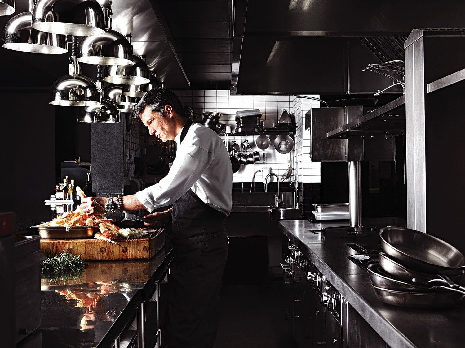 Chef David Higgs preparing food in the kitchen of his restaurant, Marble. Photo by Elsa Young. Chef David Higgs preparing food in the kitchen of his restaurant, Marble. Photo by Elsa Young.