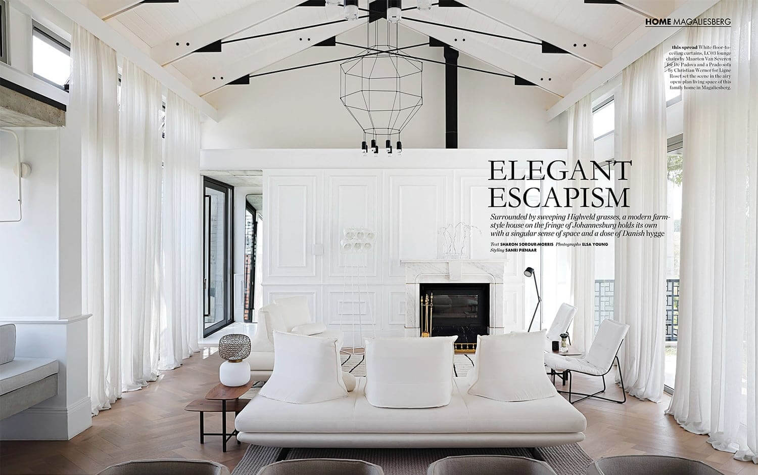 Elegant living room in black and white, with modern beam details, contemporary furniture and herringbone wooden floors. Photograph by Elsa Young.